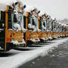 School buses parked on a snow day.